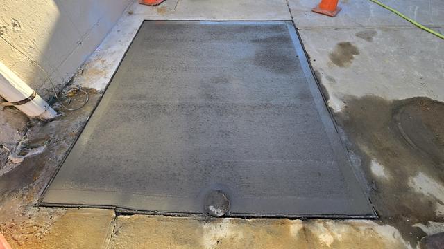 Smooth new concrete slab finished inside wood forms with clean, square edges